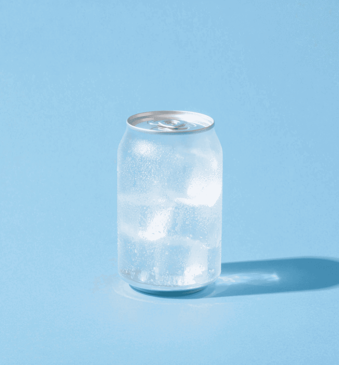 Frosted aluminum can with condensation on light blue background